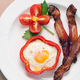 bacon on breakfast plate with pepper and egg